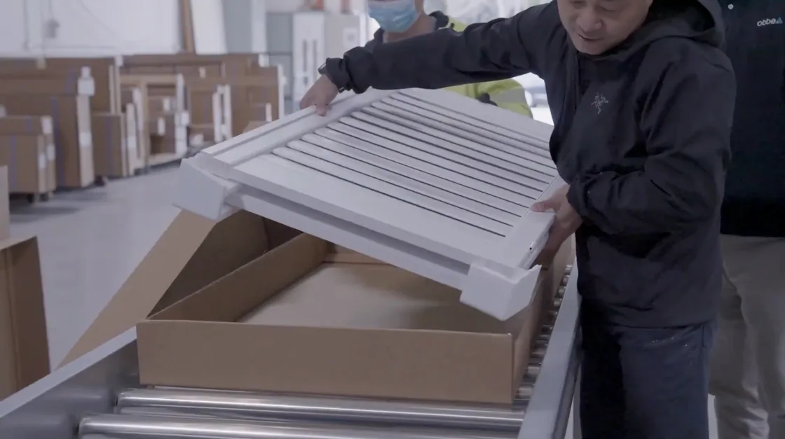 A wrapped shutter panel being placed into a cut-to-fit carton on the Abbe packaging line