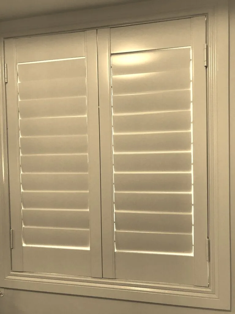 Hang strip hero Hang strip style plantation shutter panel fitted beside the window opening