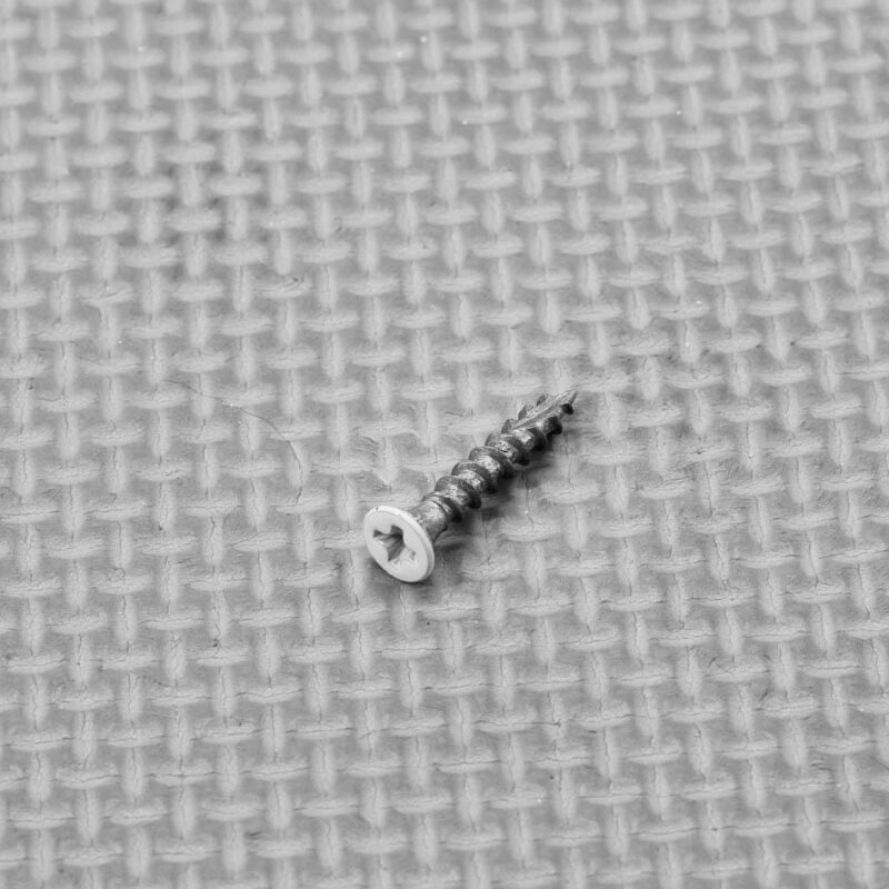 Plantation shutter hinge screw showing its countersunk head and thread