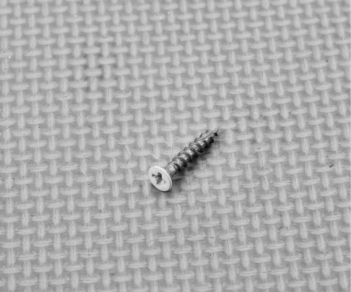 Plantation shutter hinge screw showing its countersunk head and thread